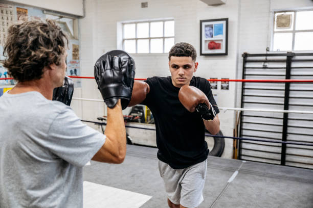 istock Teenage boxer training with focus mitts 2203068171