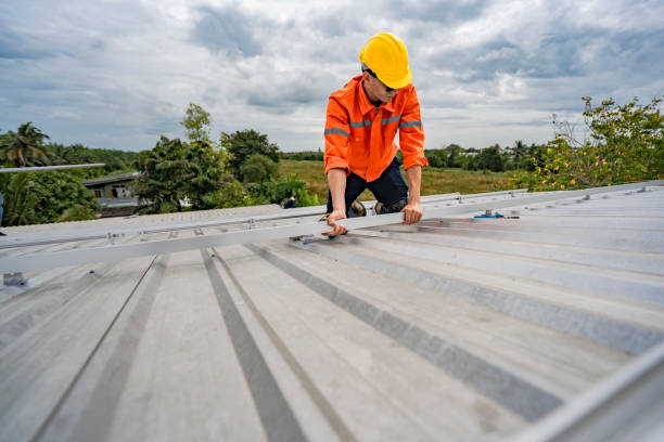 istock Technician in safety uniform and helmet kneeling on a rooftop, using a drill for precise installation work. A scene highlighting safety, professionalism, and technical expertise in construction. 2203070550