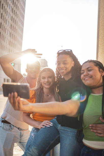 istock Group of friends taking a selfie outdoors on a sunny day 2203070608