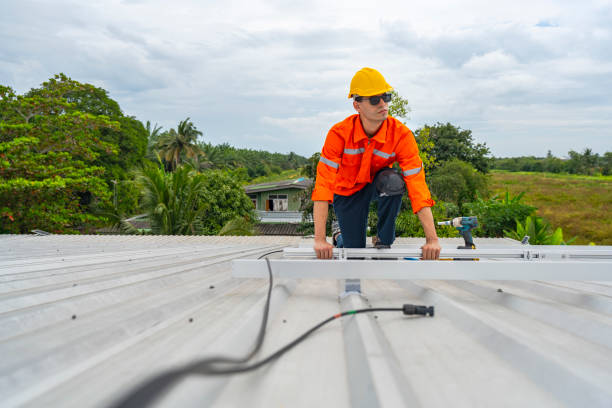 istock Technician in safety uniform and helmet kneeling on a rooftop, using a drill for precise installation work. A scene highlighting safety, professionalism, and technical expertise in construction. 2203071038