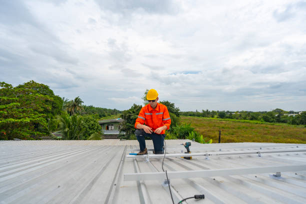 istock Technician in safety uniform and helmet kneeling on a rooftop, using a drill for precise installation work. A scene highlighting safety, professionalism, and technical expertise in construction. 2203071161