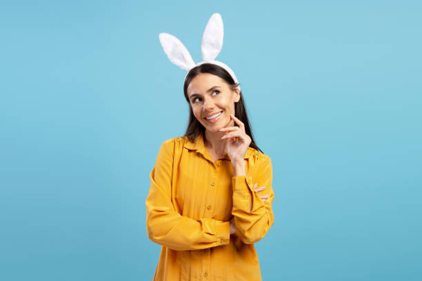 istock Young Woman Wearing Bunny Ears Thinking About Easter 2203071664