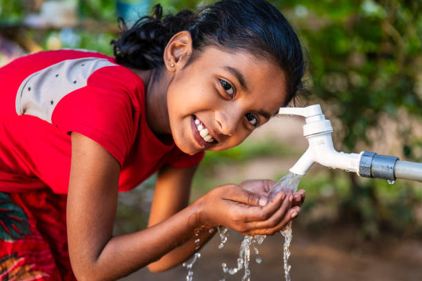 istock Sri Lankan young girl drinking a water, Ceylon 2203071736