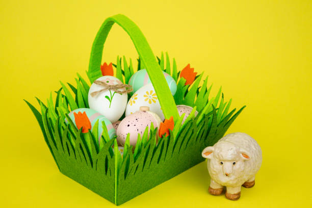 Cute decorated Easter eggs and Easter bunny are on green grasses under a clear blue sky. Easy to crop for all social media and print design sizes.