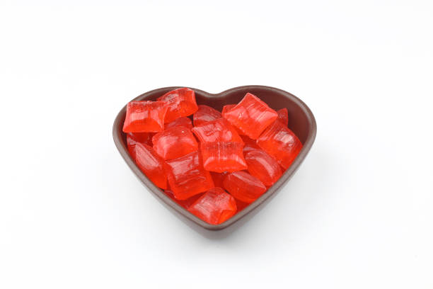 istock Red sugar in a wooden bowl on a white background. Ramadan Feast candy. 2203073526