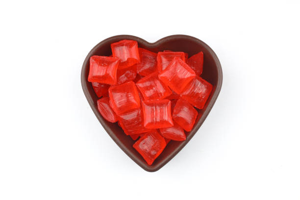 istock Red sugar in a wooden bowl on a white background. Ramadan Feast candy. 2203073661