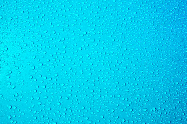 Drops on turquoise blue background. Water drops on bright blue background. Fresh blue colour. Abstarct wet texture bubbles. Raindrop, pure water droplets condensed for creative banner design.