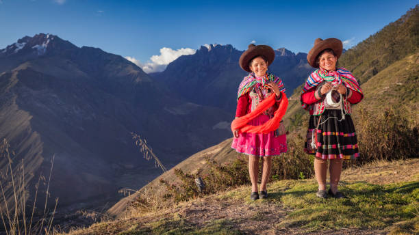istock Peruvian women spinning wool by hand in Sacred Valley, Peru 2203075214