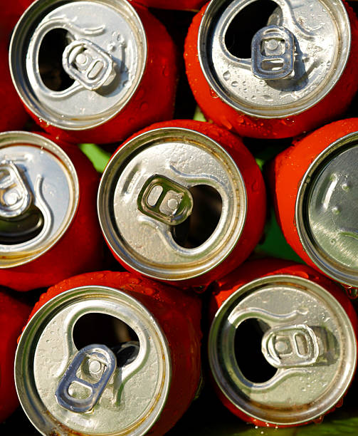 istock Opened Coke Cans background, texture. Open drink soda cans close up, top view.  Vertical photo. 2203075577