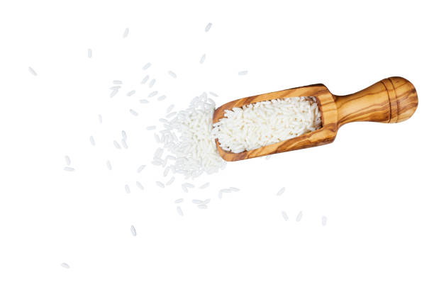 istock wooden spoon with white rice isolated on white 2203075762