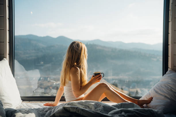 istock Young woman relaxes in bed in cabin 2203077534