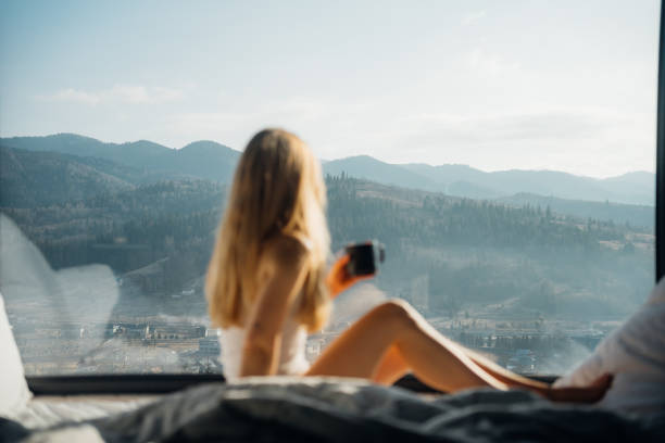 istock Young woman relaxes in bed in cabin 2203077536
