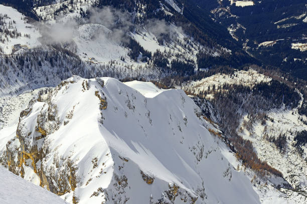 Teenage girl, women snow skier skiing, enjoying on ski resorts. Skiing carving at high speed. Lightweight fresh snow in the foreground, beautiful white powder snow in the background. Shot with Canon 5DMarkIII, developed from RAW, Adobe RGB color profile. Shallow DOF for soft background.