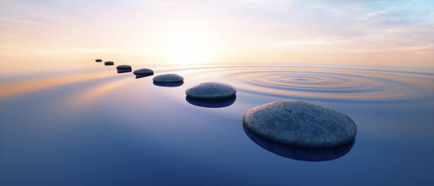istock Row of stones in calm ocean 2203079728