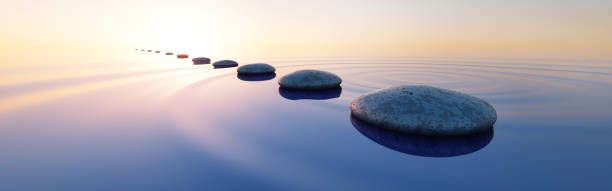 istock Row of stones in calm ocean 2203079739