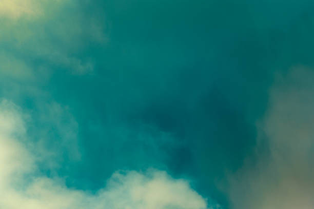 istock Teal Sky and Clouds. A colorful sky with clouds. Cloud in the background. Phone or desktop wallpaper. 2203080354