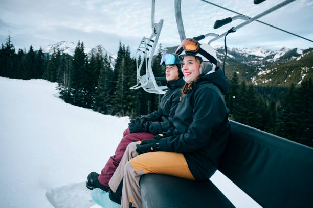 istock Snowboard Teens At Mountain on Chairlift 2203081281