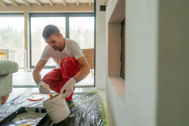 Plastering the fireplace Photo of a manual worker at construction site, plastering a fireplace drywall fireplace stock pictures, royalty-free photos & images