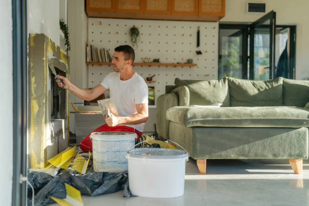 Plastering the fireplace Photo of a manual worker at construction site, plastering a fireplace drywall fireplace stock pictures, royalty-free photos & images