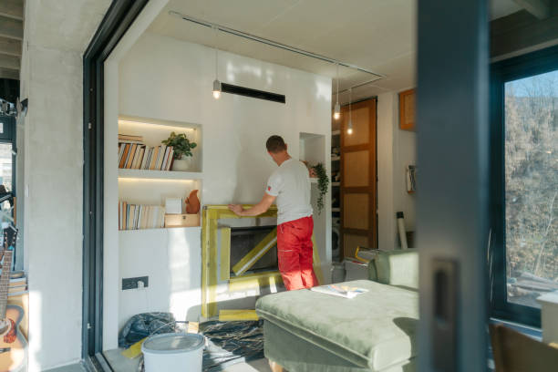 Plastering the fireplace Photo of a manual worker at construction site, plastering a fireplace drywall fireplace stock pictures, royalty-free photos & images