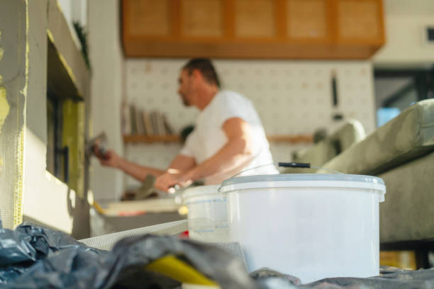 Plastering the fireplace Photo of a manual worker at construction site, plastering a fireplace drywall fireplace stock pictures, royalty-free photos & images