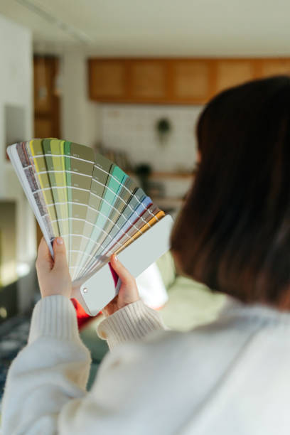 istock Choosing a wall paint shade from a colour swatch 2203081652