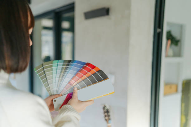 istock Choosing a wall paint shade from a colour swatch 2203081692
