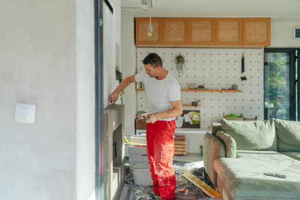 Plastering the fireplace Photo of a manual worker at construction site, plastering a fireplace drywall fireplace stock pictures, royalty-free photos & images