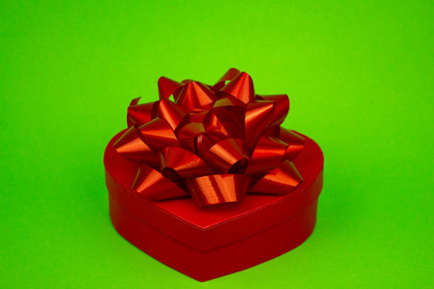 Woman hands holding a gift box on white background.