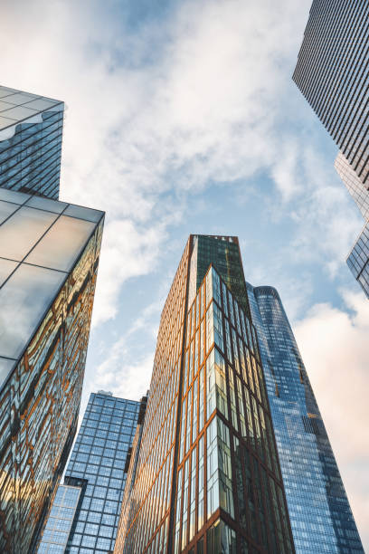 istock low angle view on modern glass facades in Manhattan at sunset 2203085397