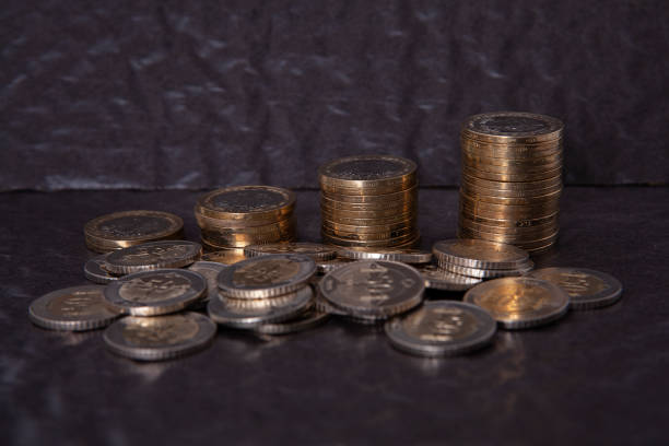 istock Close-up of coins stack on black background. Saving money concept. 2203087062