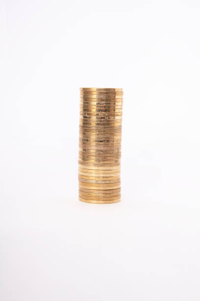 istock Close-up of coins stack on white background. Saving money concept. 2203087150