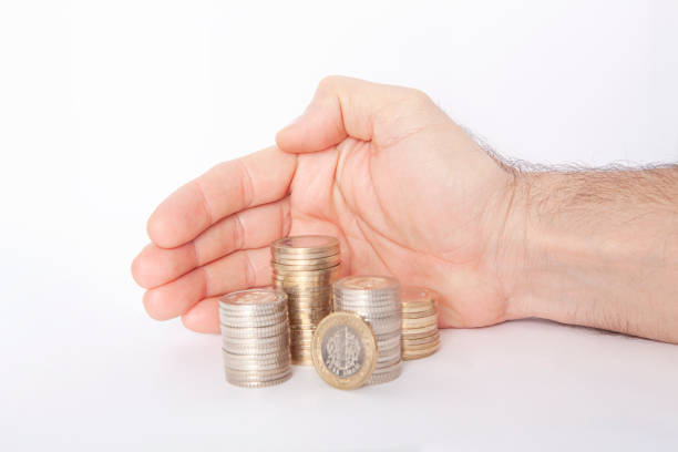 Man protecting and securing money on desk. Saving money concept.