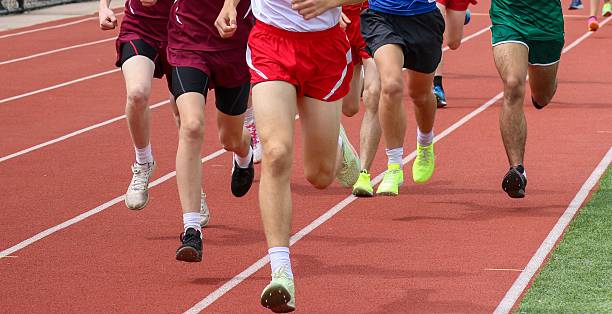 istock Exciting Track Event Featuring Young Athletes Running in a Race on a Track 2203087563