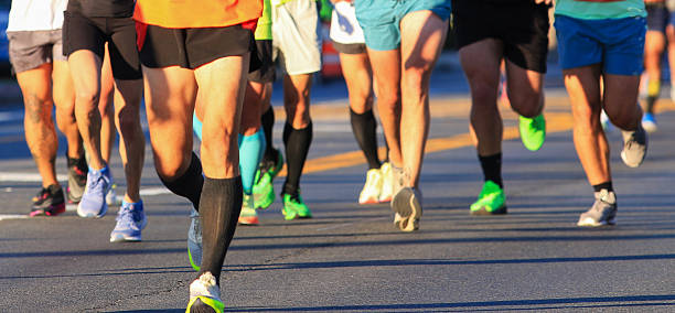 istock Runners Compete During a Marathon Event on a Sunny Day in a Vibrant Urban Area 2203087579