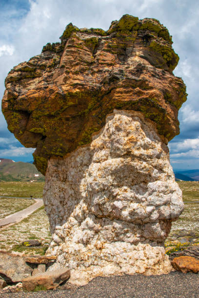 Unique Rock Formation Stands Tall Against a Dramatic Sky in a Remote Landscape