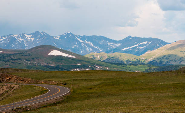 istock Scenic Mountain Landscape With Winding Road and Vibrant Green Fields During Daylight 2203087624