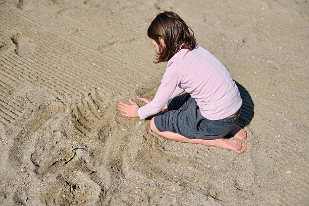 istock Young Child Enjoying Creative Sand Play on a Sunny Summer Day at the Beach 2203090653