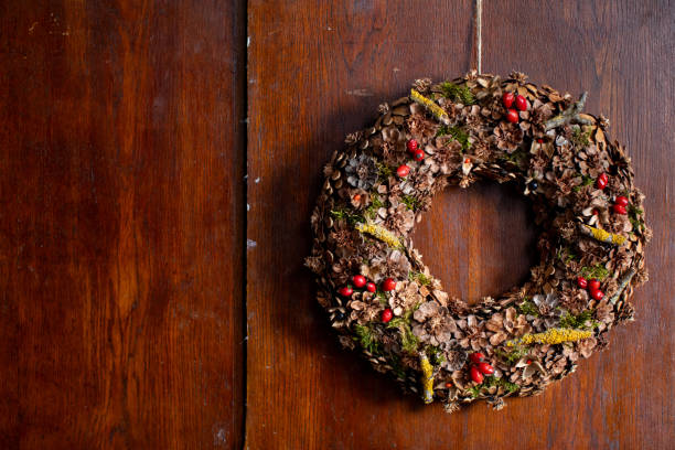 istock A beautifully arranged rustic holiday wreath set against a charming wood background 2203092307