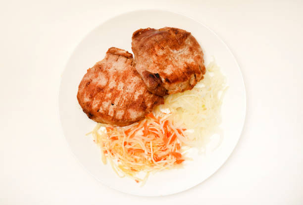 Roast pork loin with salad. Delicious meat breakfast.