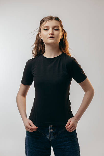 istock Stylish  girl wearing black t-shirt posing in studio 2203094111