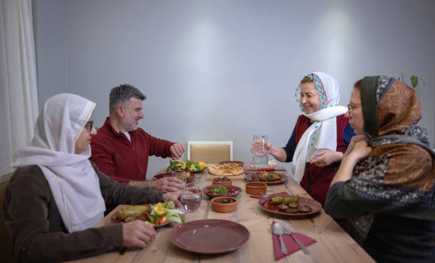 istock During Ramadan, a devout Muslim family waits at the dinner table for iftar time 2203094185