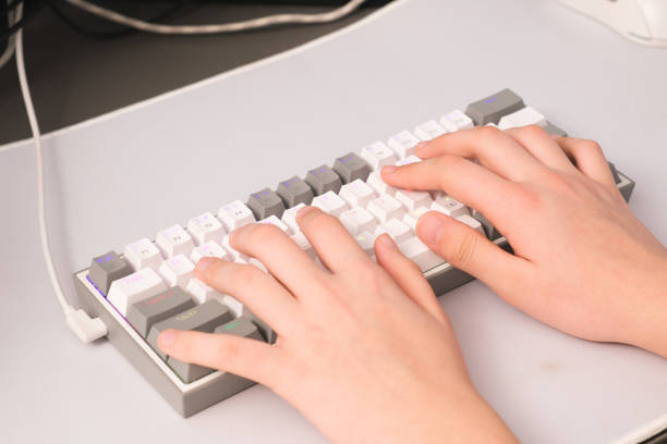 istock Hands are actively Typing on a Modern Mechanical Keyboard designed for productivity and comfort 2203096558