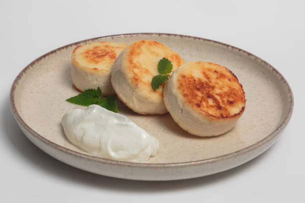 a simple but delicious dish, a variation of cottage cheese pancakes, served with a creamy garnish, condensed milk and fresh mint leaves for extra flavour