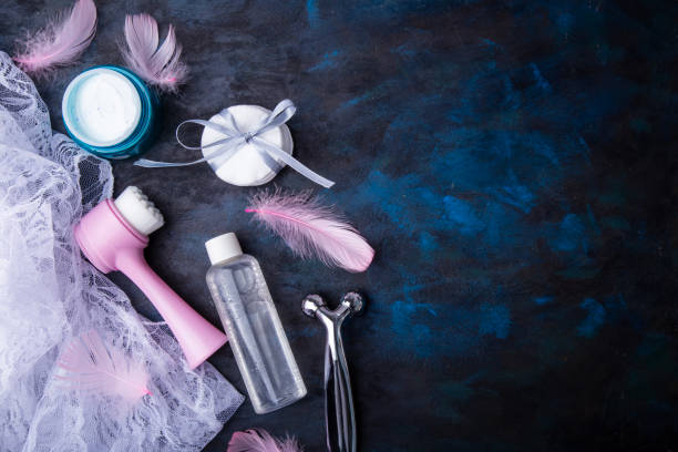 istock Pink skincare accessories on blue rustic backdrop. Beauty and wellness concept. Copy space 2203101074