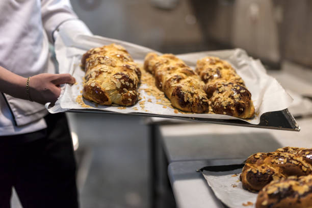 istock Pastry chef holding a tray full of freshly baked breads 2203104149