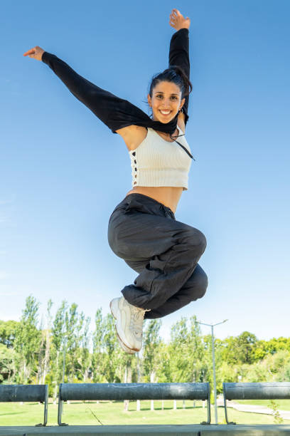 istock Urban dancer soaring with joy in a vibrant city park 2203105114