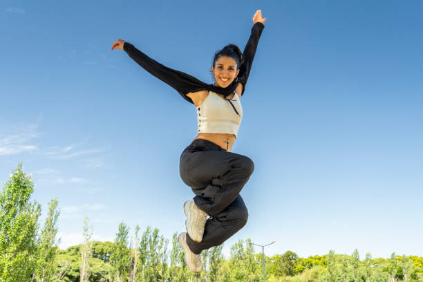 istock Dynamic dance jump by a vibrant urban performer in the park 2203105115