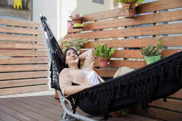 istock Relaxing on a cozy terrace hammock at home 2203105755