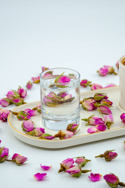 istock Pink rose buds in a water glass 2203106914